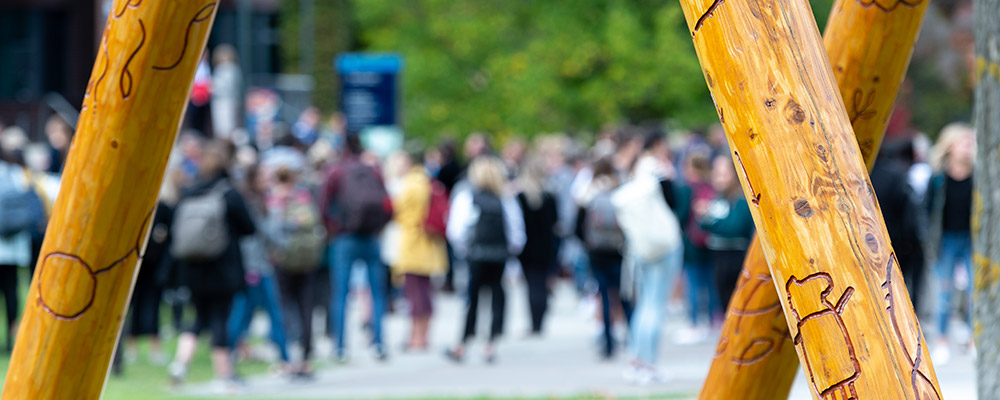 Blurred people in background, welcome post.