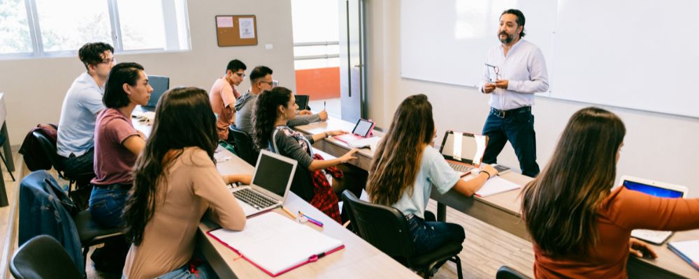 Students seated in a classroom as the lecturer speaks