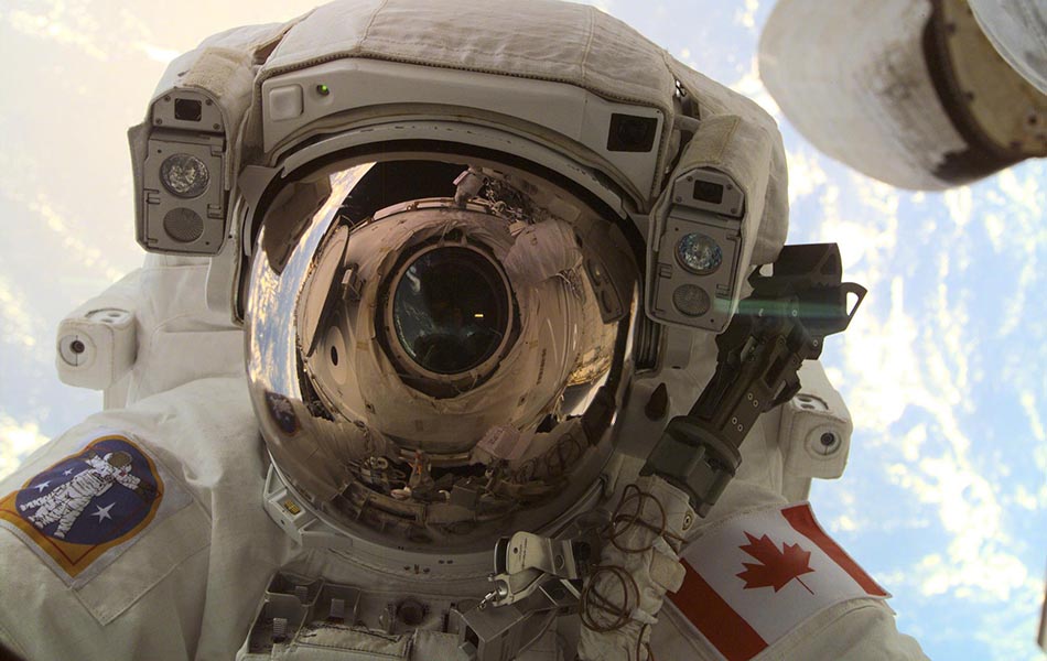 A through-the-window view of astronaut Chris A. Hadfield, STS-100 mission specialist representing the Canadian Space Agency, taken during the first extravehicular activity of the STS-100 mission.