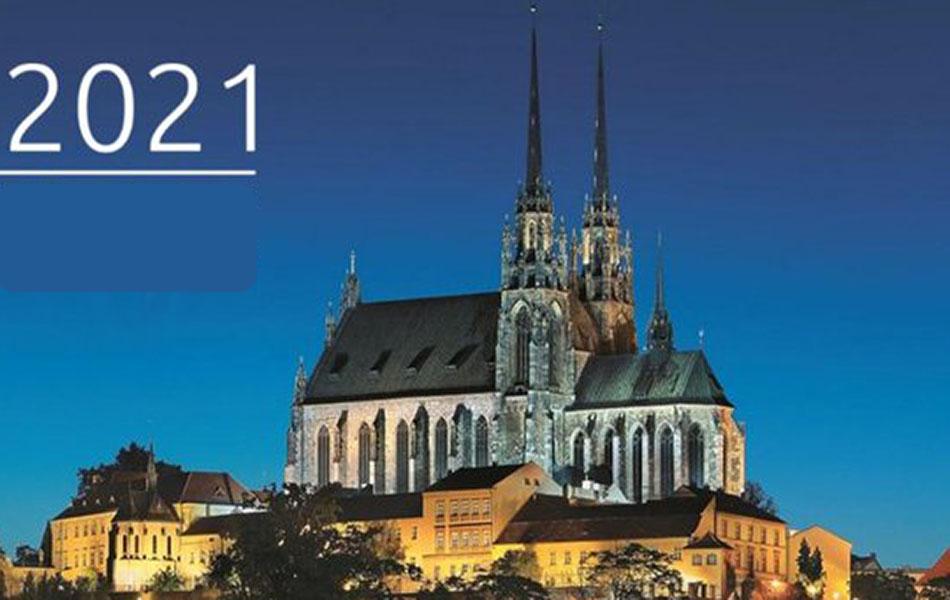 An image of a church in the Czech Republic standing on a hill against the blue night sky