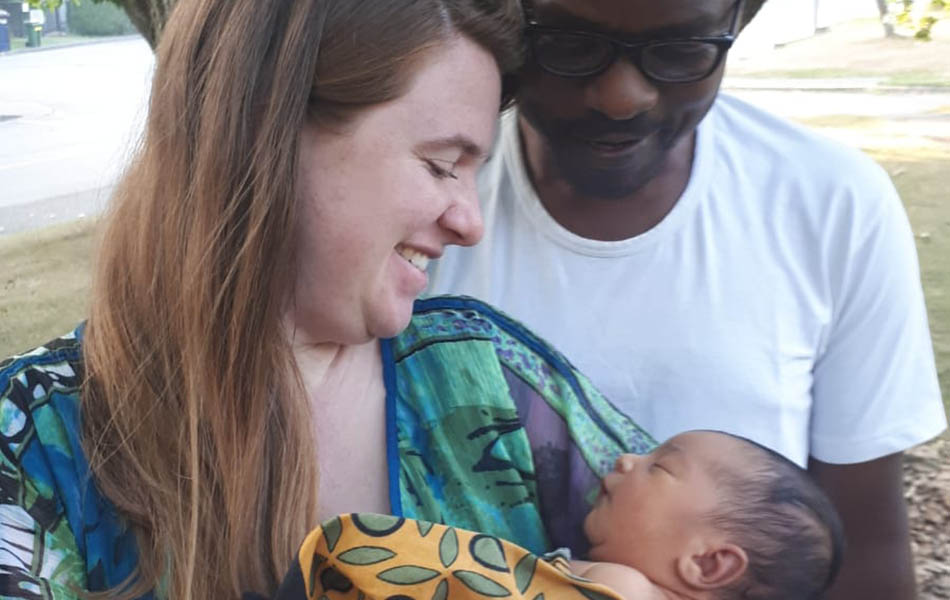 A photo of Monica Shank Lauwo holding her son, Makusaro, with her husband Lauwo