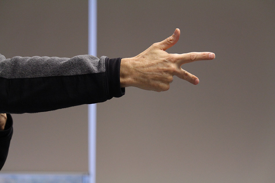 A close up of Nigel Howards hand extended in an ASL sign