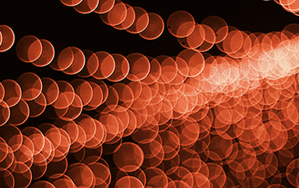 A picture of bubbles against a red background with a light shining from the right