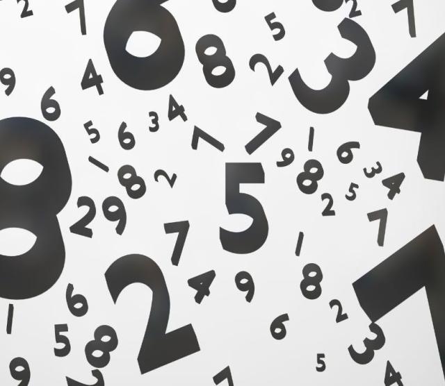 Graphic image of black-coloured numbers scattered on a white background