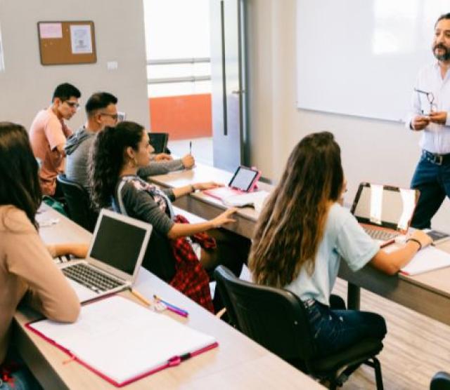 Students seated in a classroom as the lecturer speaks