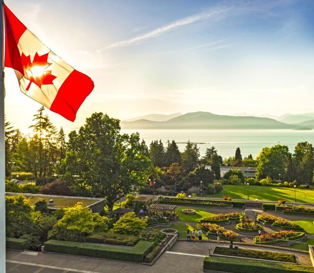 A picture of the UBC Rose Garden, with the Canadian flag in the foreground.