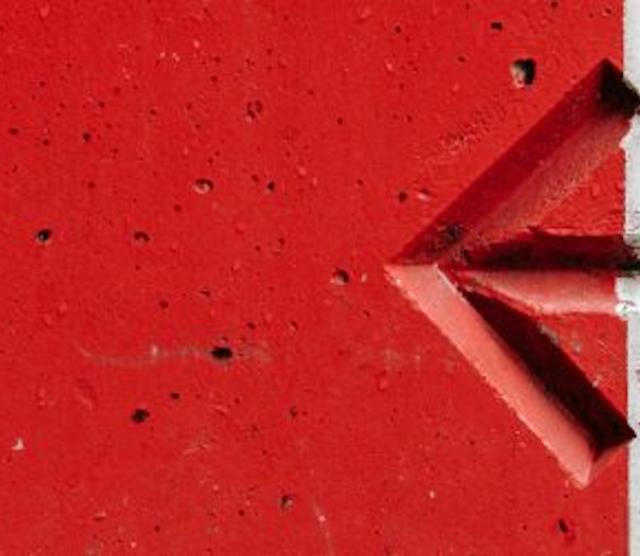 A picture of an arrow pointing left, on a red and white background