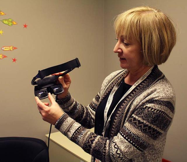 Language Sciences member professor Deborah Giaschi holds a 3D headset which is testing binocular treatment for amblyopia.