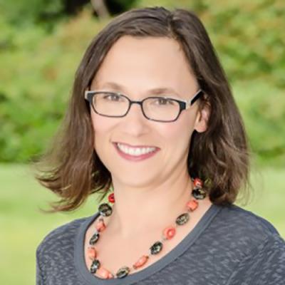 A headshot of Stefania Burk standing outside
