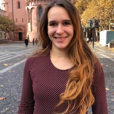 A headshot of Annina Hessel standing outside in a city