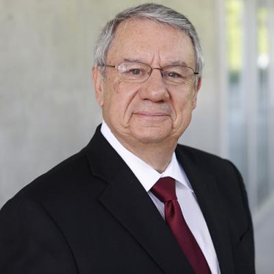 A headshot of Izak Benbasat standing outside