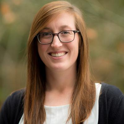 A headshot of Lauren Schneider standing outside