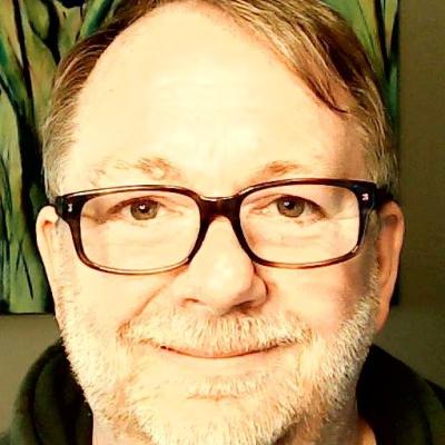 A headshot of Neil Leveridge wearing glasses