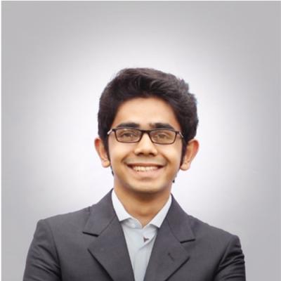 A headshot of Mohi Reza standing against a grey background