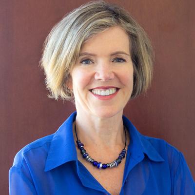 A hadshot of Wendy Carr against a brown background