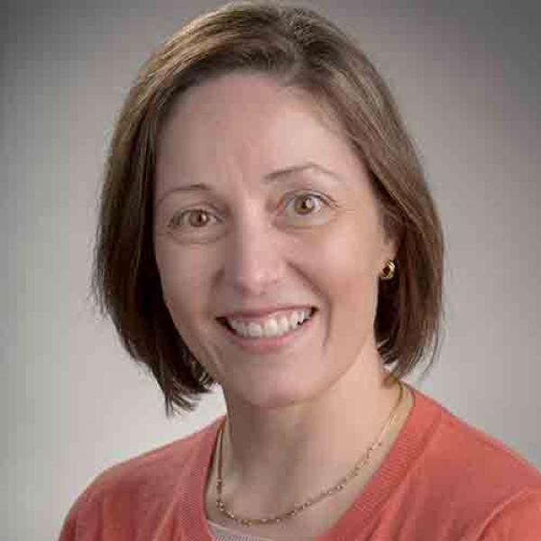 A headshot of Maite Taboada against a grey background